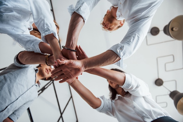 Group of people putting their hands together